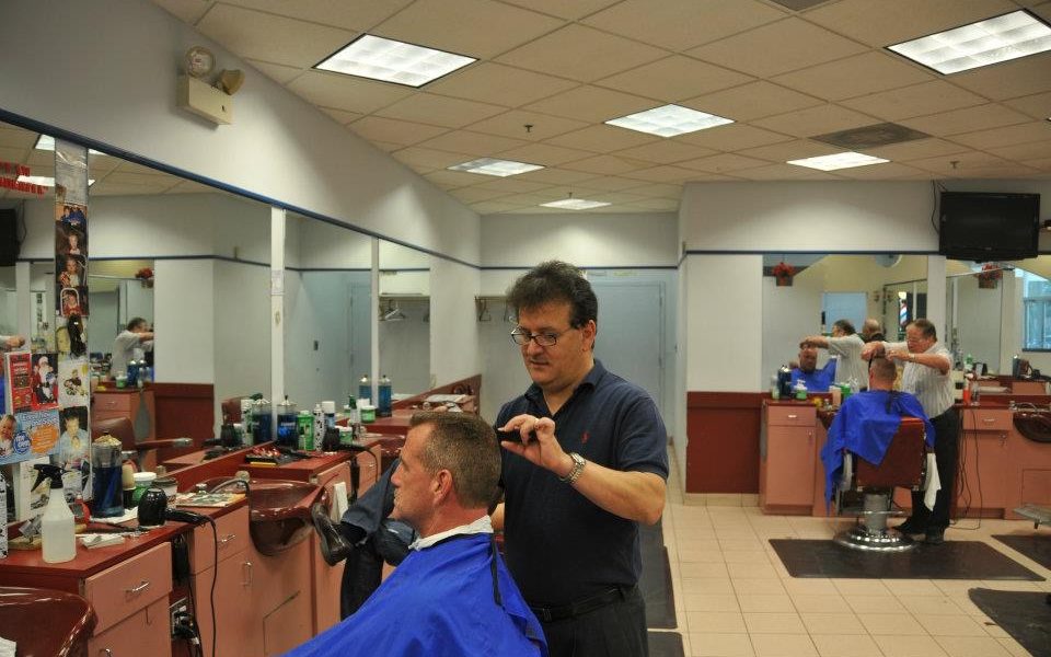 A barber cutting the client’s hair