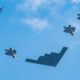 US military jet fighters and bombers flying in formation