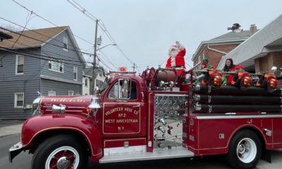 Santa Claus on top of a firetruck