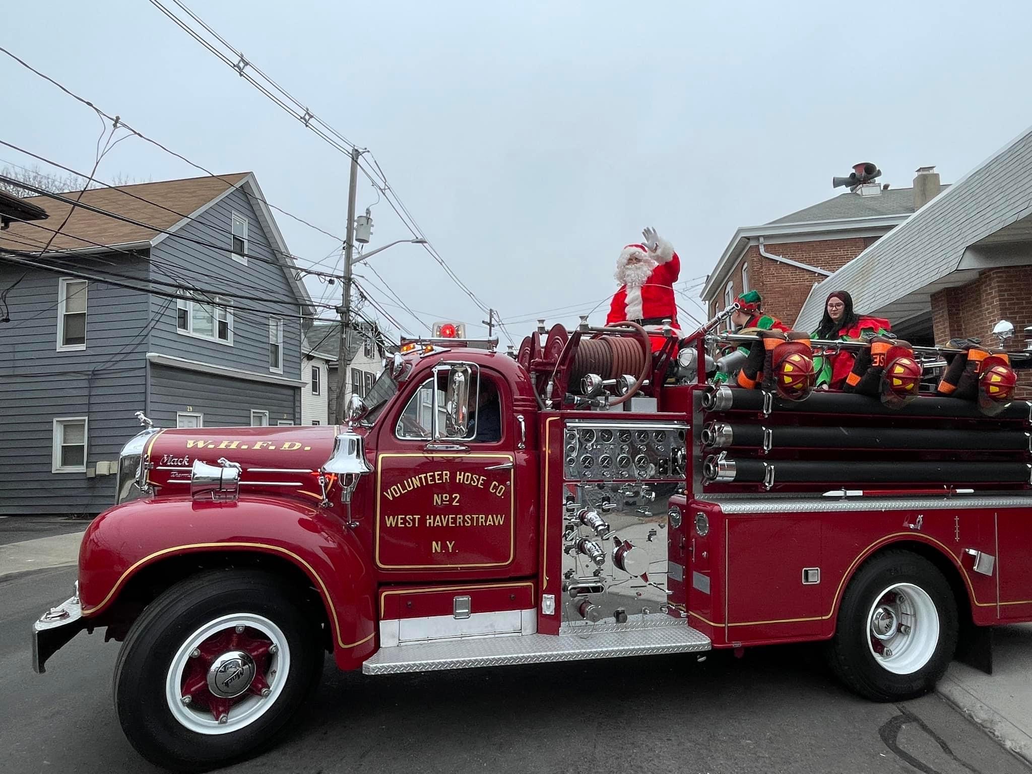 Santa Claus on top of a firetruck