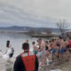 People in their swimwear entering the lake