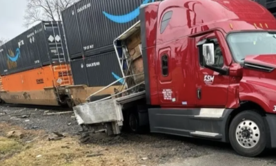A damaged truck next to containers