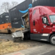 A damaged truck next to containers