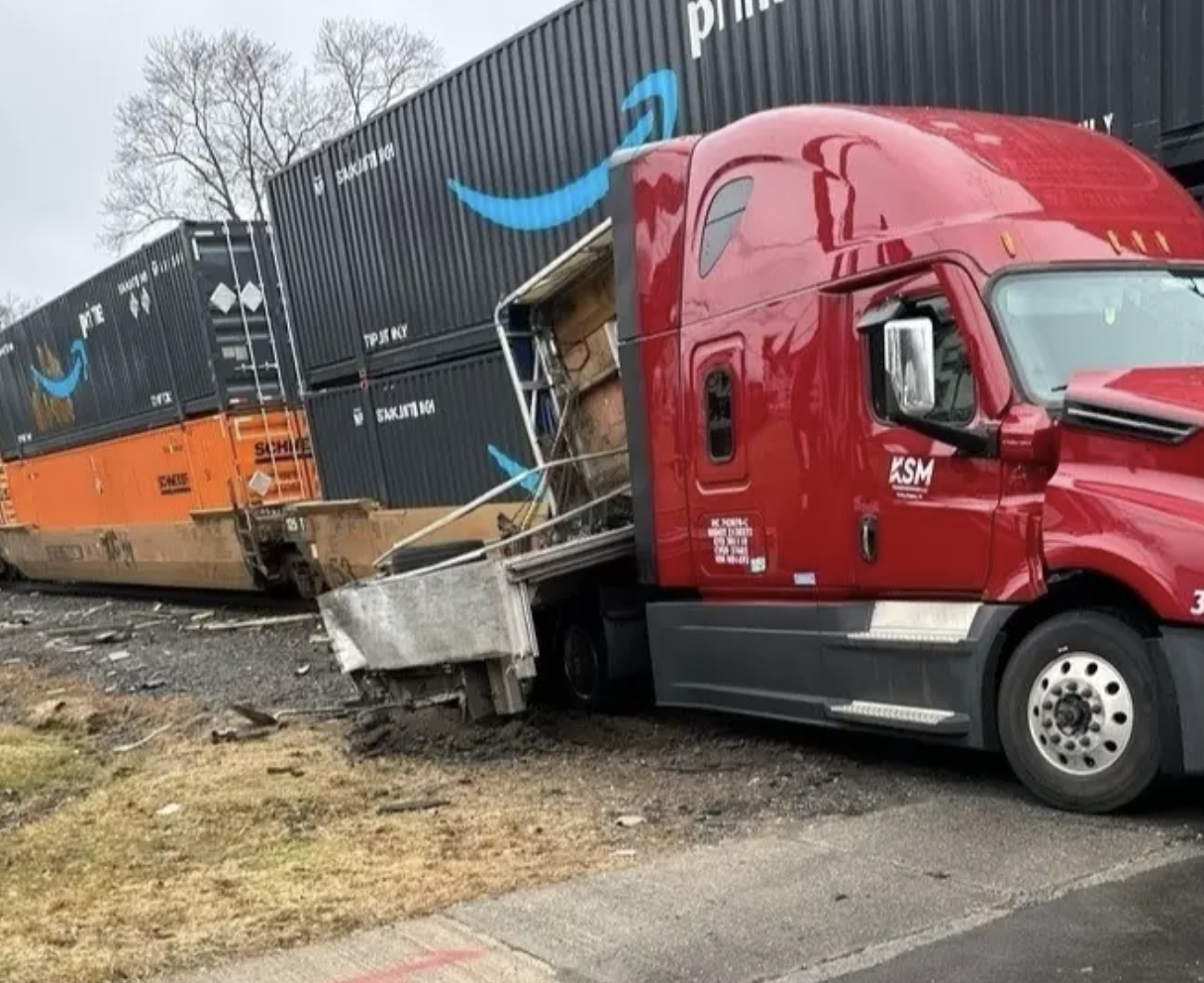 A damaged truck next to containers