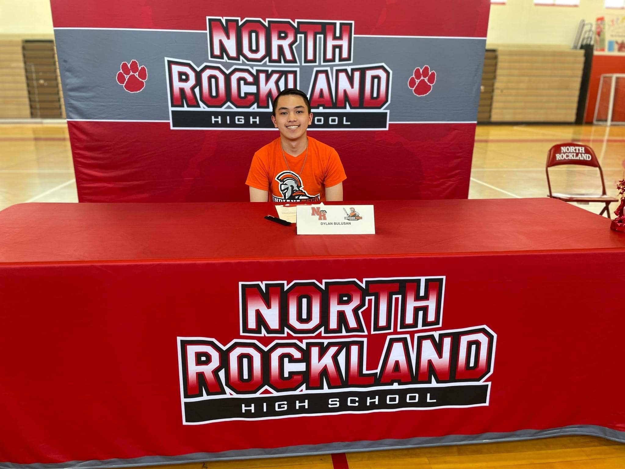 A man sitting at a table dedicated to North Rockland Highschool